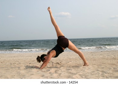 woman on beach doing yoga