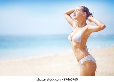 woman on the beach having tropical shower - Powered by Shutterstock