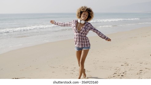 Woman On Beach Listening To Music On Smart Phone Happy Dancing.