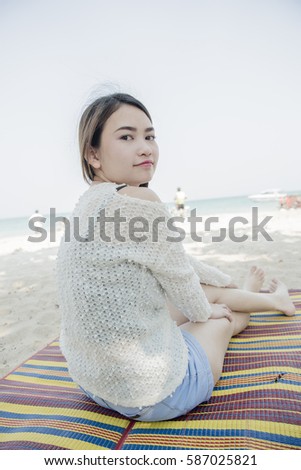 woman on the beach looking away at around