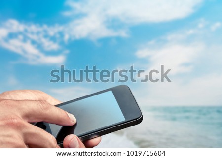 Woman on the beach with a phone