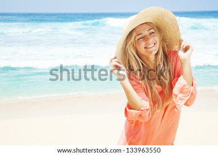 woman on the beach in pink shirt