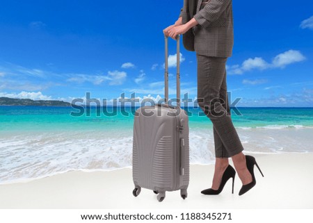 
woman on the beach with a suitcase