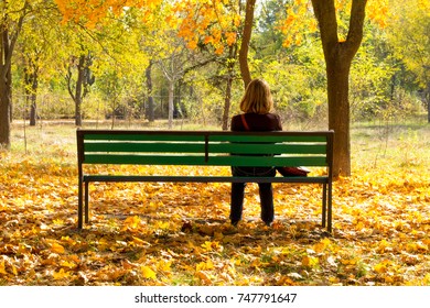 A woman on a bench in park