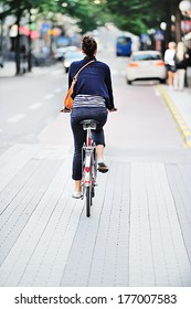 Woman On Bike In Green Summer City