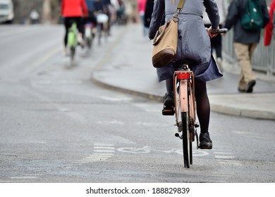 Woman On Bike In Light Rain On Her Way Home From Work