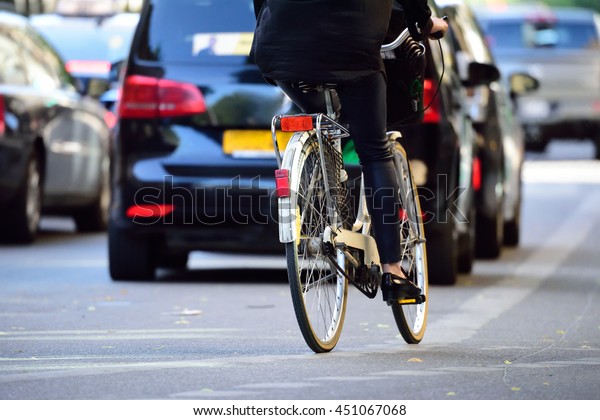 Woman on bike in\
traffic