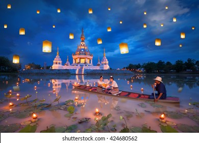 Woman on boat for kratong and floating lamp festival in pagoda background