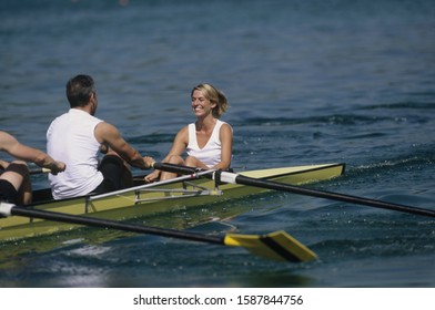 Woman On Boat With Rowers