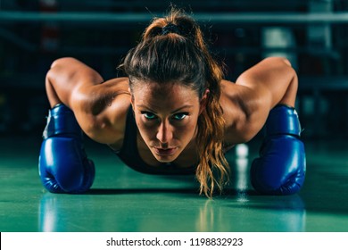 Woman on boxing training doing push ups - Powered by Shutterstock