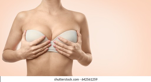 Woman on color background. Breast correction and plastic surgery concept