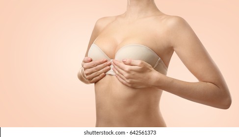 Woman On Color Background. Breast Correction And Plastic Surgery Concept