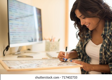 Woman On Computer Desk Writing On A Calendar