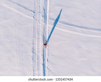 Woman On Cross-country Skiing Rides On Snowy Track. Leisure Concept. Aerial Top View.