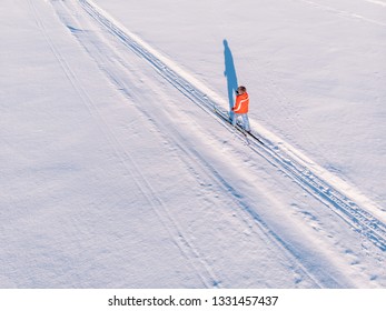 Woman On Cross-country Skiing Rides On Snowy Track. Leisure Concept. Aerial Top View.