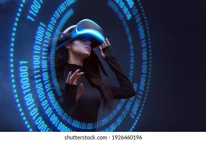 Woman on dark virtual reality background. Female using VR helmet. Augmented reality, future technology, game concept. Blue neon light. Futuristic holographic interface to display data. - Powered by Shutterstock