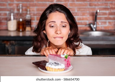 Woman On The Diet Craving To Eat Cake.  Young Attractive Woman Really Wants To Eat Delicious Cake. Diet Concept