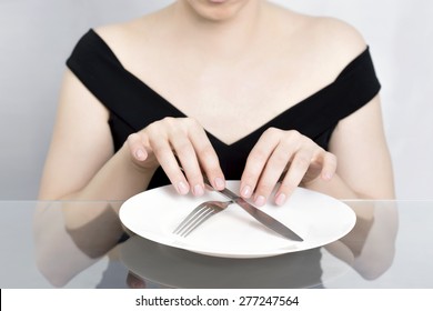 Woman On Diet, Dining In Front Of Empty Plate