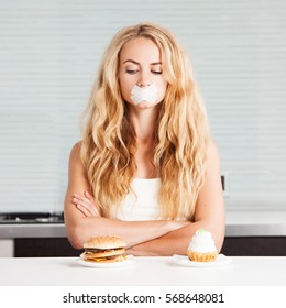 Woman on a diet. Girl with mouth sealed looking for food