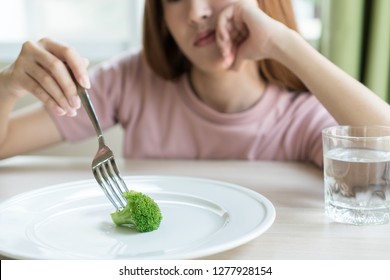 Woman On Dieting. Depressed Teen Looking At Her Empty Plate Dinner.