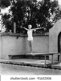 Woman On Diving Board At Swimming Pool