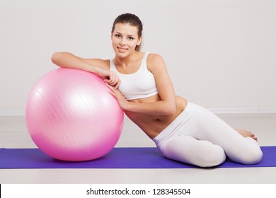 Woman On A Fitness Ball In A Gym