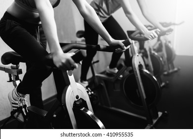 Woman On Fitness Exercise Bike At Indoor