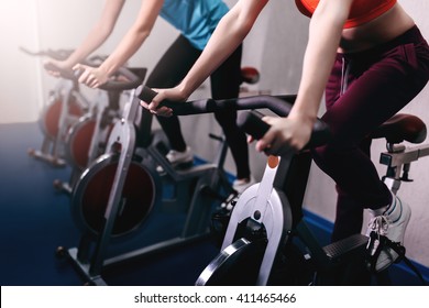 Woman on fitness exercise bike at indoor