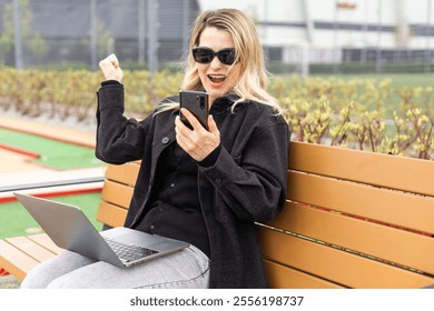 woman on golf course with smartphone with sports betting app - Powered by Shutterstock