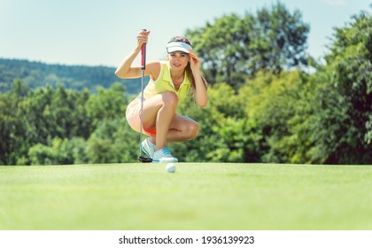 Woman on golf course taking measure on the green - Powered by Shutterstock