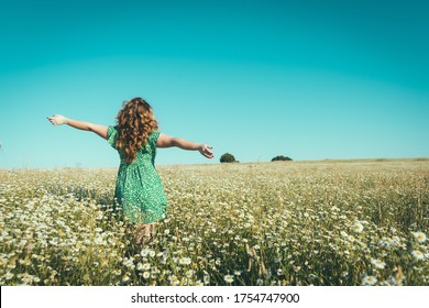 Woman On Her Back With Open Arms In A Field Of Daisies