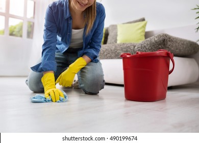 Woman On Her Knees Cleaning The Floor Close Up