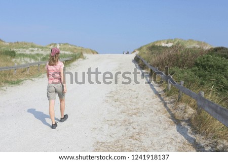 Woman on island Ameland. Wadden and North sea