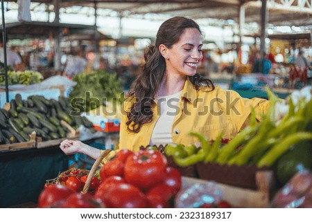 Woman on the market. Mature Female Customer Shopping At Farmers Market Stall. Woman shopping at the local Farmers market. Beautiful woman buying vegetables. ストックフォト © 