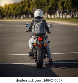 A woman on a motorcycle wearing a white helmet 