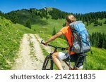 Woman on a mountain bike tour to the Fockenstein between Tegernsee and Lenggries in the Bavarian Alps 