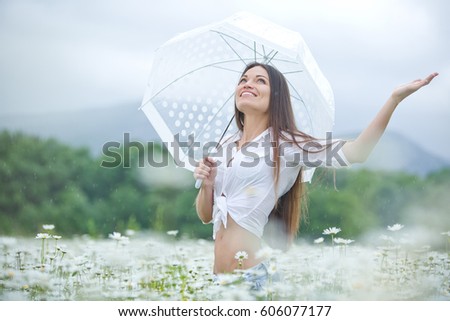 Woman on the nature in the rain