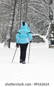 Woman On Nordic Walking Exercise In Winter Park