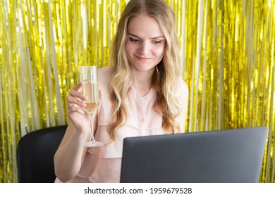 Woman On Online Corporate Party Or Online Dating With A Laptop At The Table Drinks Champagne From A Glass. Internet Celebration, Virtual Love Concept.