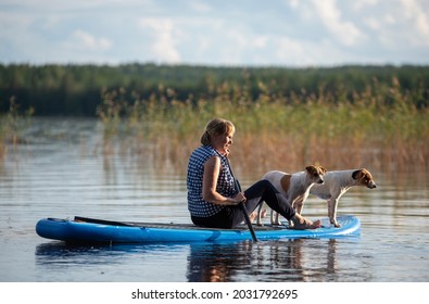 
Woman on paddleboard with dog
