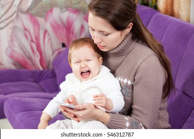 The Woman On The Phone, Ignores The Crying Child. The Baby Is Crying