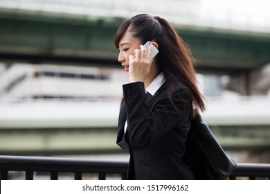 A woman is on the phone while walking