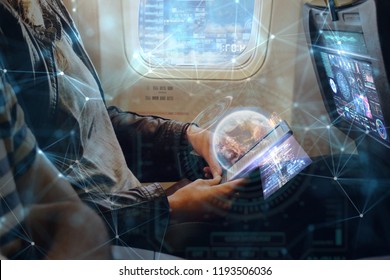 A Woman On Plane Uses The Phone Thanks To The Wi-fi Present In Flight. He Uses Holography Futuristic. Concept Of: Travel, Vacation, Technology, Future.