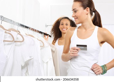 Woman On Purchases Paid By Credit Card.Woman In Clothing Store Pay For Purchases By Credit Card. 