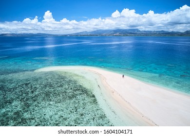 Woman On Remote Island In Fiji Overlooking Blue Coral Reef