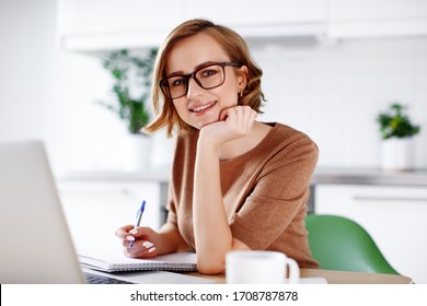 Woman On Remote Work Or Online Education, Using Laptop Computer, Papers And Notes, Indoors At Office Or Home At Daytime. Remote Teaching On Learning Courses For New Profession Or Getting New Skills