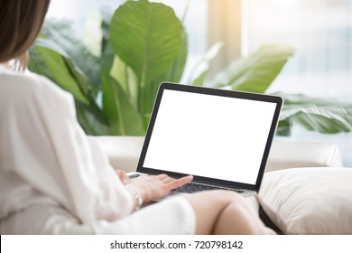 Woman On Sofa Working On Laptop With Mockup Blank Screen. Empty Copyspace On Monitor For  Advertisement, Language Learning Ad, Online Shopping Website, Social Media Site. Close Up, Focus On Screen.