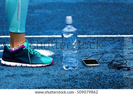 woman on track with mobile phone