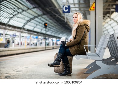 Woman on train station platform waiting on bench