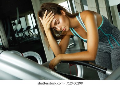Woman On The Treadmill With Overtraining Symptoms